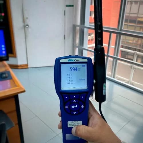 Blue handheld instrument beside a window